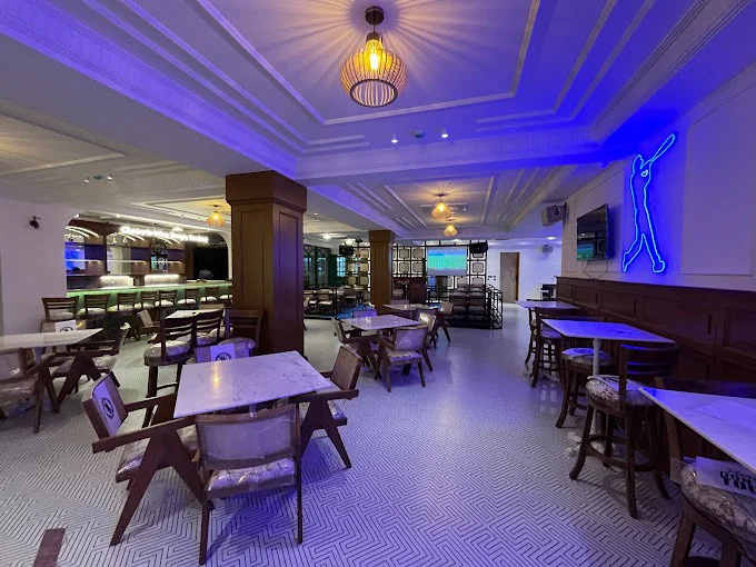 A view of the dining area at The Studs in Bangalore, showcasing the unique seating and decorative wall panels.