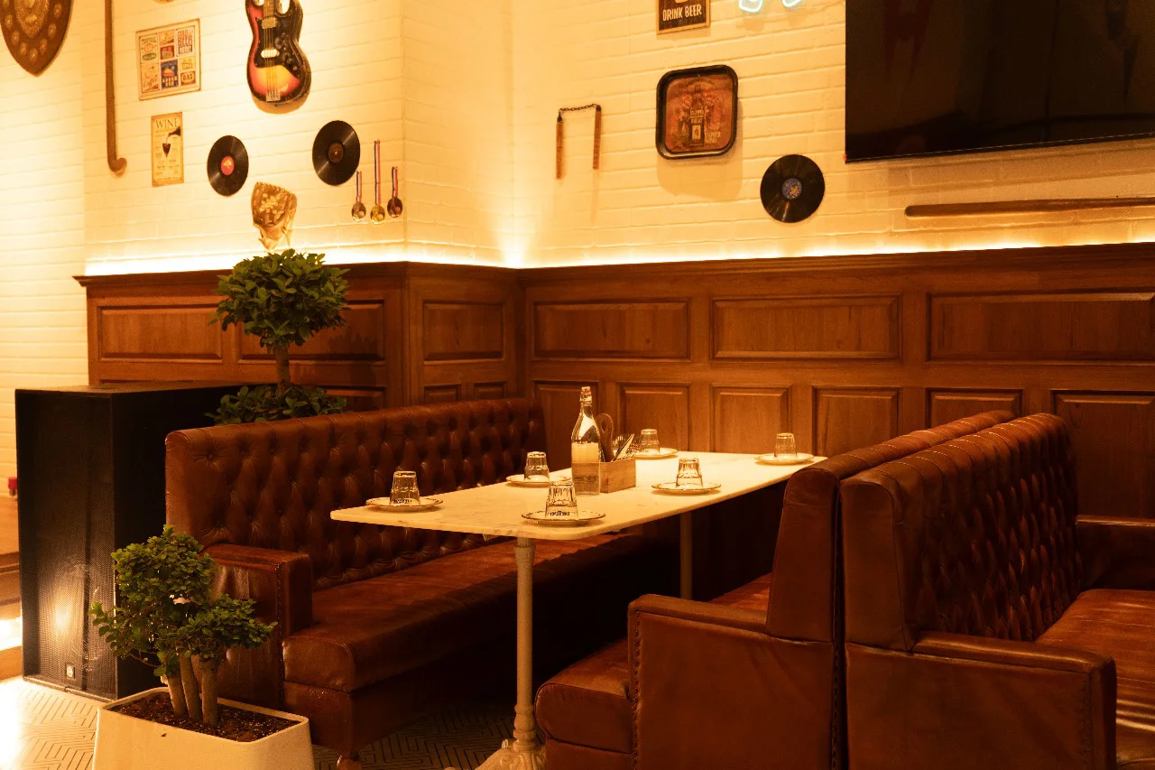 Close-up of the stylish dining booth area at The Studs - Pune, highlighting the attention to detail in our hospitality interior design.