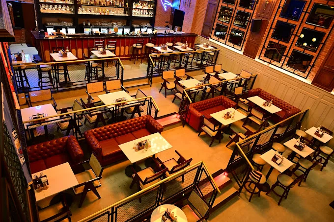 An elevated view of the spacious, multi-level seating area at The Studs - Ranchi, showcasing the unique design of this 4700 sq. ft. sports bar.